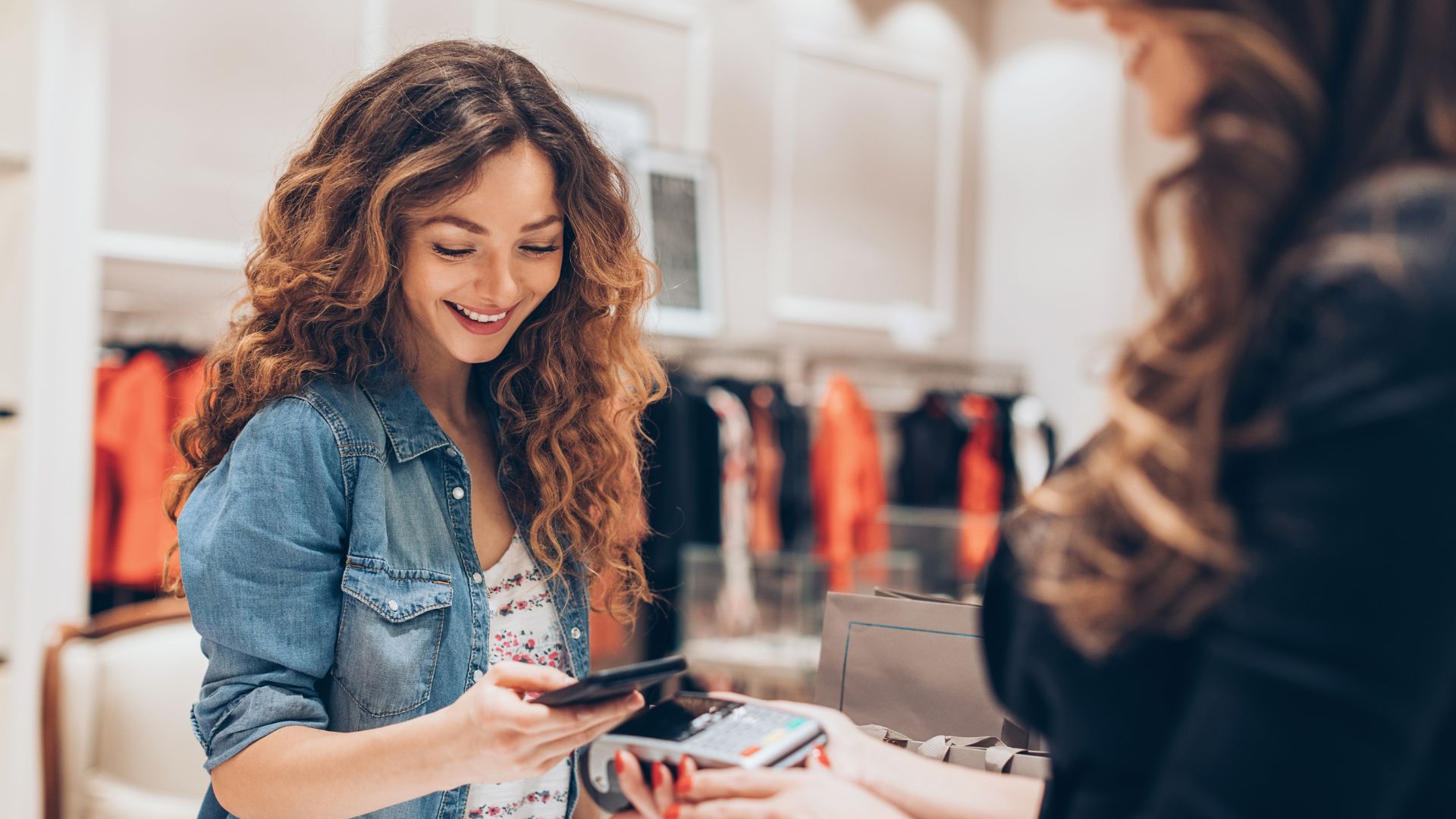 Female retail customer paying electronically through EFT